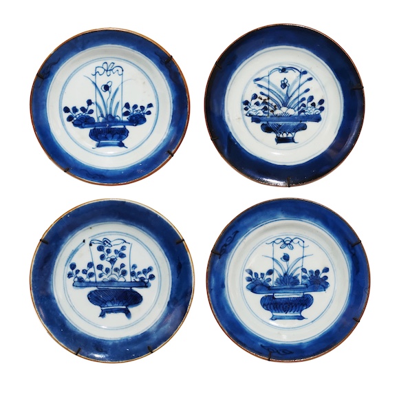 Four pieces of qing 18th - 19th century Chinese blue and white saucers each painted with basket of flowers