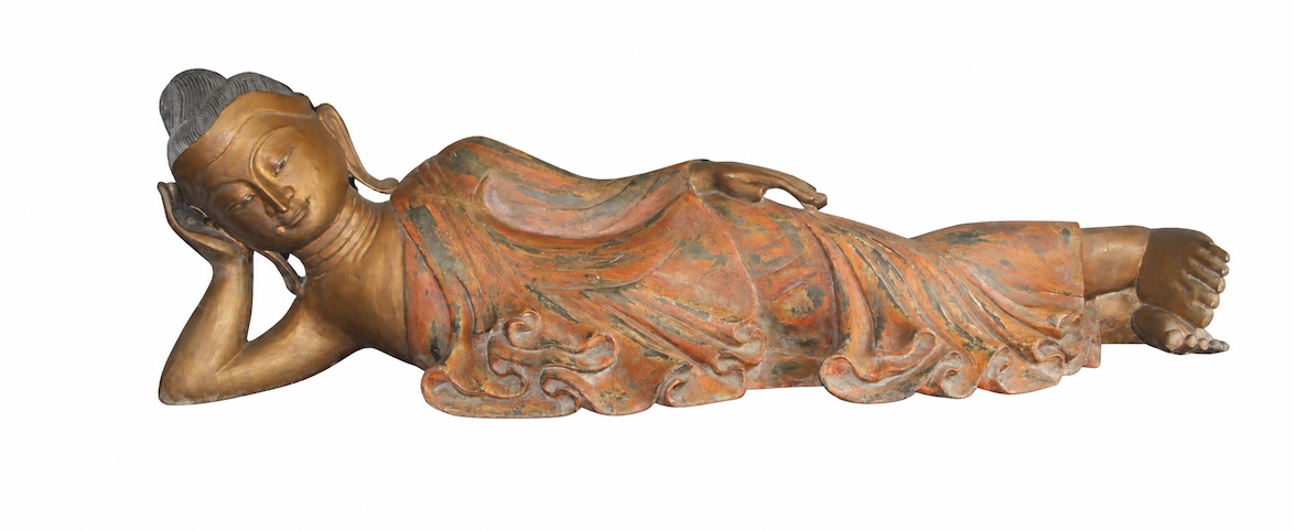 A South East Asian carved and lacquered wood of reclining buddha