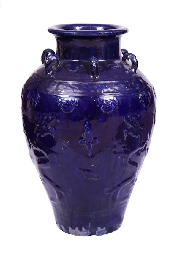 A 18th - 19th century Qing dynasty Chinese blue glazed storage jar with molded dragons
